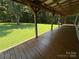 View from covered porch to spacious, green lawn and mature trees beyond at 265 River Run Rd, Statesville, NC 28625