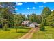 Charming home featuring a welcoming front porch and well-maintained lawn in a serene setting at 265 River Run Rd, Statesville, NC 28625