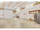 Large garage with high ceiling, work bench and roll-up door to outside at 265 River Run Rd, Statesville, NC 28625