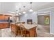 Eat-in kitchen features an island with granite countertop and leads to a fireplace sitting area at 265 River Run Rd, Statesville, NC 28625