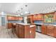Traditional kitchen with wood cabinetry, stainless steel appliances, island with seating, and a garden window at 265 River Run Rd, Statesville, NC 28625