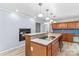 Eat-in kitchen features an island with granite countertop and a cozy fireplace area at 265 River Run Rd, Statesville, NC 28625