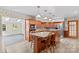 Charming kitchen with wood cabinets, a granite-topped island with seating, and stainless steel appliances at 265 River Run Rd, Statesville, NC 28625