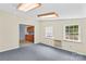 Living room adjacent to kitchen features neutral walls, plush carpeting, and natural light at 265 River Run Rd, Statesville, NC 28625