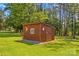 This outbuilding provides practical storage with a charming design, set in a lush yard at 265 River Run Rd, Statesville, NC 28625