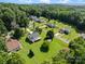 Aerial view of this homes well-maintained lawn, mature trees and its location in a quiet residential neighborhood at 2906 Plantation Way, Albemarle, NC 28001