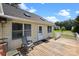 A wooden deck with a white railing, offering outdoor seating and views of the backyard and clear blue sky at 2906 Plantation Way, Albemarle, NC 28001