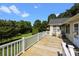 Large wooden deck with white railings, providing an outdoor living area and view of the spacious backyard at 2906 Plantation Way, Albemarle, NC 28001