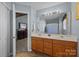 Bathroom with a double sink vanity, a well-lit mirror, and a view to the Main Bedroom at 2906 Plantation Way, Albemarle, NC 28001