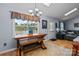 Dining area with natural light, rustic table, and easy access to the living room at 2906 Plantation Way, Albemarle, NC 28001