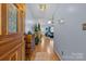 Open foyer leading into the living room featuring hardwood floors, natural light, and neutral paint at 2906 Plantation Way, Albemarle, NC 28001