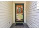 Close-up of a front door featuring decorative glass and house number, inviting entry to the home at 2906 Plantation Way, Albemarle, NC 28001