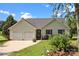 Inviting single-story home showcasing an attached two-car garage, surrounded by vibrant landscaping and a well-maintained lawn at 2906 Plantation Way, Albemarle, NC 28001