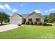 Single Gathering home featuring a well-manicured lawn, mulched flower beds, and a two car garage at 2906 Plantation Way, Albemarle, NC 28001
