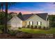 Charming single Gathering home featuring a well-manicured lawn and a two car garage at dusk at 2906 Plantation Way, Albemarle, NC 28001