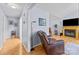 Hallway leading to the fireplace, with hardwood floors, and a brown leather recliner at 2906 Plantation Way, Albemarle, NC 28001