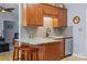 View of kitchen featuring granite countertops, wood cabinets, and stainless steel dishwasher at 2906 Plantation Way, Albemarle, NC 28001