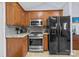 Kitchen featuring wooden cabinets, stainless steel appliances, and tile backsplash at 2906 Plantation Way, Albemarle, NC 28001