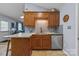 Kitchen features granite countertops, tile backsplash, stainless steel dishwasher, and custom wood cabinetry at 2906 Plantation Way, Albemarle, NC 28001