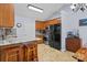 Well-lit kitchen featuring wooden cabinets, stainless steel appliances, and a breakfast bar at 2906 Plantation Way, Albemarle, NC 28001