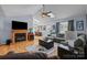 Bright living room featuring hardwood floors, a fireplace, and natural light at 2906 Plantation Way, Albemarle, NC 28001