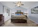 Spacious main bedroom boasts a tray ceiling, ceiling fan, and neutral décor at 2906 Plantation Way, Albemarle, NC 28001