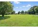Large backyard with expansive lawn, mature trees, and open space at 29636 Lakeside Dr, Albemarle, NC 28001