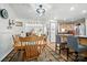 Bright eat-in kitchen open to the dining area with barstool seating and modern lighting at 29636 Lakeside Dr, Albemarle, NC 28001
