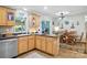 Functional kitchen with warm wood cabinetry, a cozy breakfast bar, and natural light at 29636 Lakeside Dr, Albemarle, NC 28001