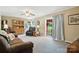 Spacious living room featuring comfortable seating, a sliding glass door, and warm ambiance at 29636 Lakeside Dr, Albemarle, NC 28001
