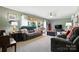 Comfortable living room with large windows, neutral colors, and a ceiling fan at 29636 Lakeside Dr, Albemarle, NC 28001