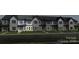 Modern townhome featuring a stylish facade with gray brick and siding, showcasing contemporary design and curb appeal at 3136 Beacon Heights Rd, Indian Land, SC 29707