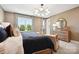 This bedroom is awash in natural light and features stylish modern lighting and calming earth tones at 327 Ardmore Dr, Belmont, NC 28012