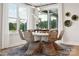 Stylish dining area featuring a unique chandelier, modern decor, and natural light from large windows at 327 Ardmore Dr, Belmont, NC 28012