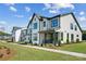 Attractive new construction townhomes with inviting exteriors, manicured lawns, and sidewalks at 327 Ardmore Dr, Belmont, NC 28012