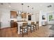 Bright kitchen with an island, pendant lighting, stainless appliances, and an adjacent door at 327 Ardmore Dr, Belmont, NC 28012