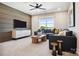 A comfortable living room has a wall-mounted tv, stylish furniture, and lots of natural light at 327 Ardmore Dr, Belmont, NC 28012