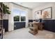 A bright office space has paneled walls, contemporary art, and a modern desk at 327 Ardmore Dr, Belmont, NC 28012