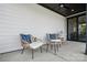 Inviting covered patio with stylish wicker chairs and a glass-topped table, perfect for relaxing outdoors at 327 Ardmore Dr, Belmont, NC 28012