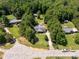 Aerial view of the property with a swimming pool, outbuilding, mature trees, and a long driveway at 4030 Orion Rd, York, SC 29745