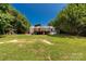 Sprawling backyard with wooden deck, above-ground pool, and surrounded by mature trees, offering a private retreat at 4030 Orion Rd, York, SC 29745