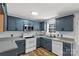 Well-lit kitchen features blue cabinets, stainless steel appliances, and stylish countertops at 4030 Orion Rd, York, SC 29745