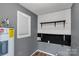 Laundry area with shelving and modern gray walls at 4030 Orion Rd, York, SC 29745