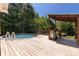Outdoor deck featuring a partially covered area, built-in grill, and an above-ground pool for relaxation at 4030 Orion Rd, York, SC 29745