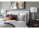 Comfortable main bedroom featuring a well-made bed, stylish pillows, and modern decor at 4114 Lattistep Ln, Charlotte, NC 28269