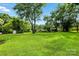 Expansive backyard with lush green grass, mature trees, and a fenced perimeter at 450 1St Se St, Hickory, NC 28602