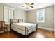 Bedroom with metal frame bed, hardwood floors, and natural light from two windows at 450 1St Se St, Hickory, NC 28602