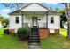 Home exterior with stairs leading to the front door and well-maintained lawn at 450 1St Se St, Hickory, NC 28602