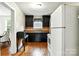 Functional kitchen with black cabinets, wood floors, and a bright window at 450 1St Se St, Hickory, NC 28602