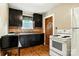 A charming kitchen with dark cabinetry, hardwood flooring, and a window above the sink at 450 1St Se St, Hickory, NC 28602